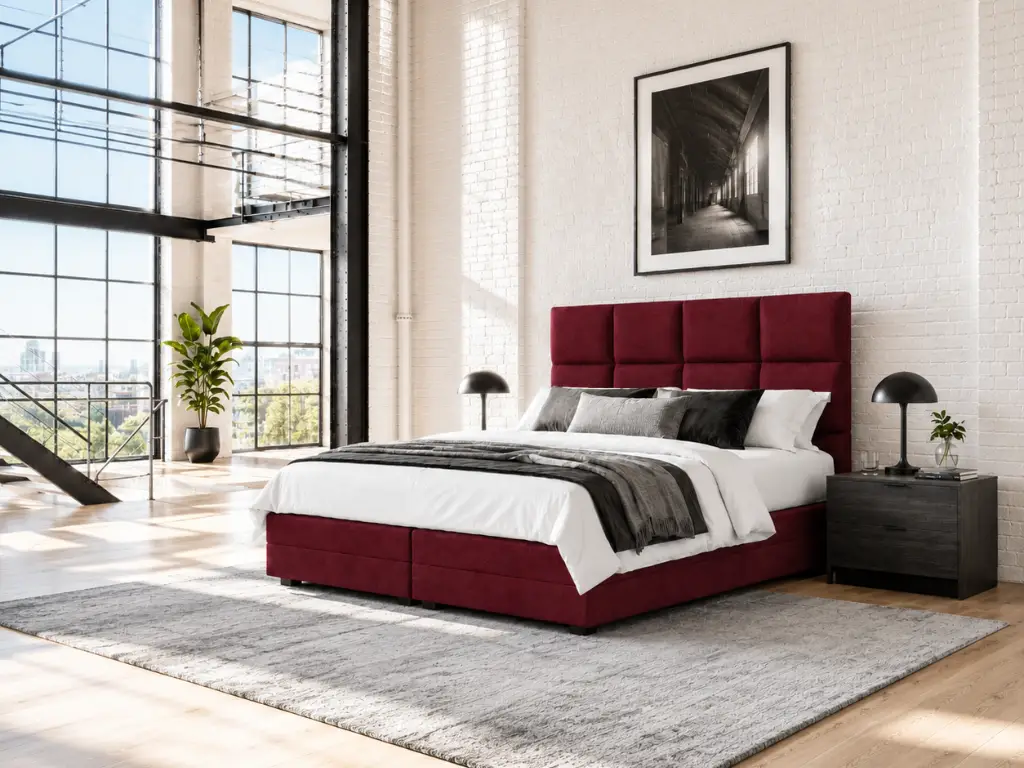 Boxspringbett in Dunkelrot in einem hellen Loft-Schlafzimmer